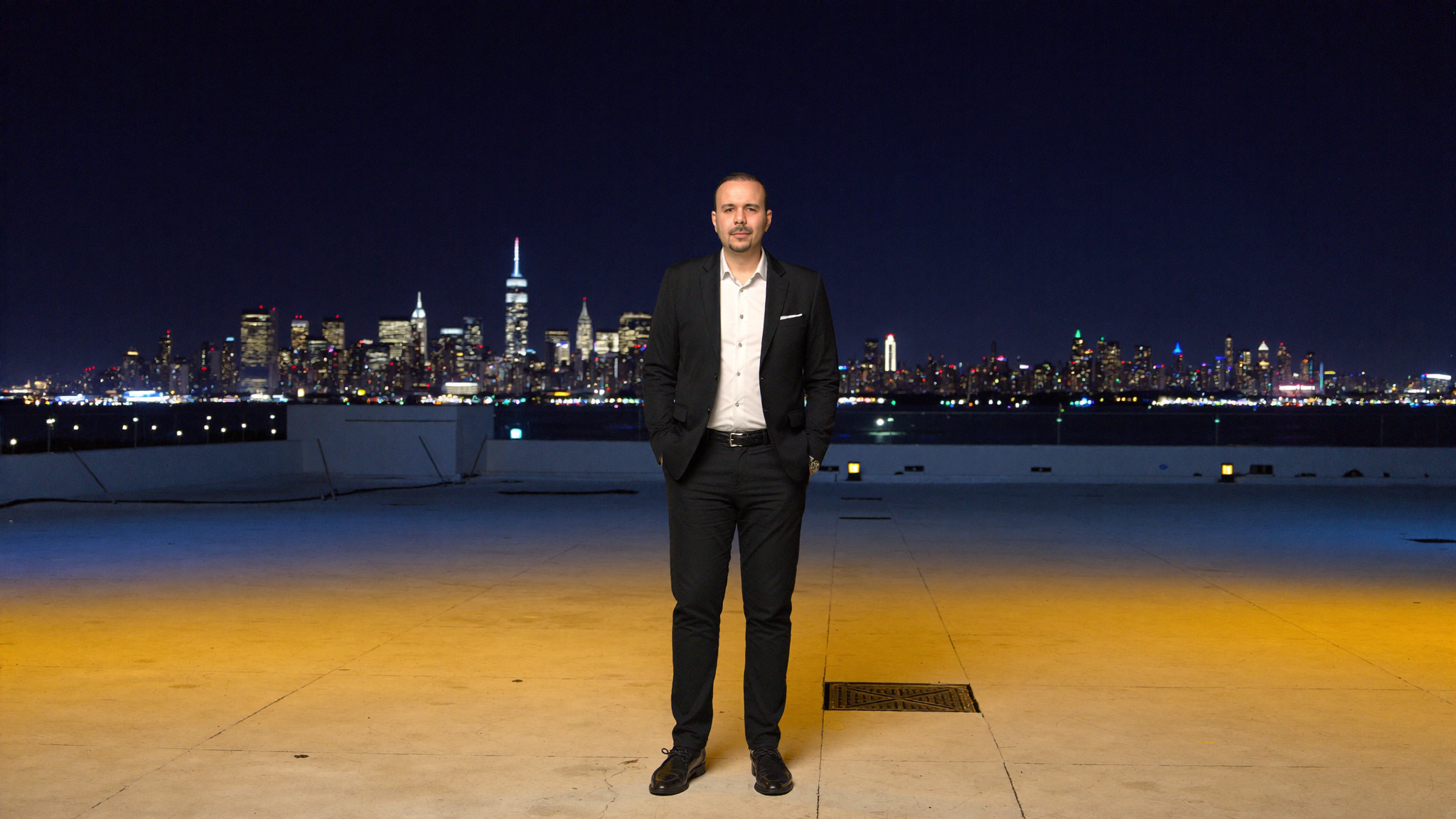 JB Bolvadin on rooftop with NYC skyline